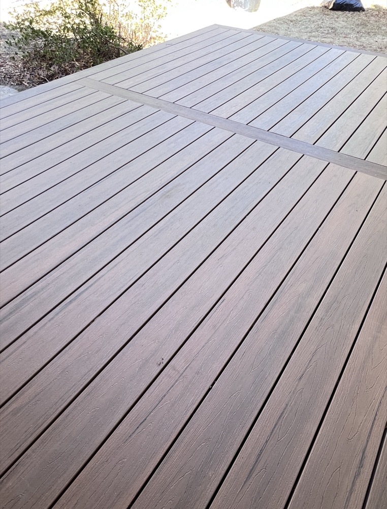 Finished composite deck with trees behind it